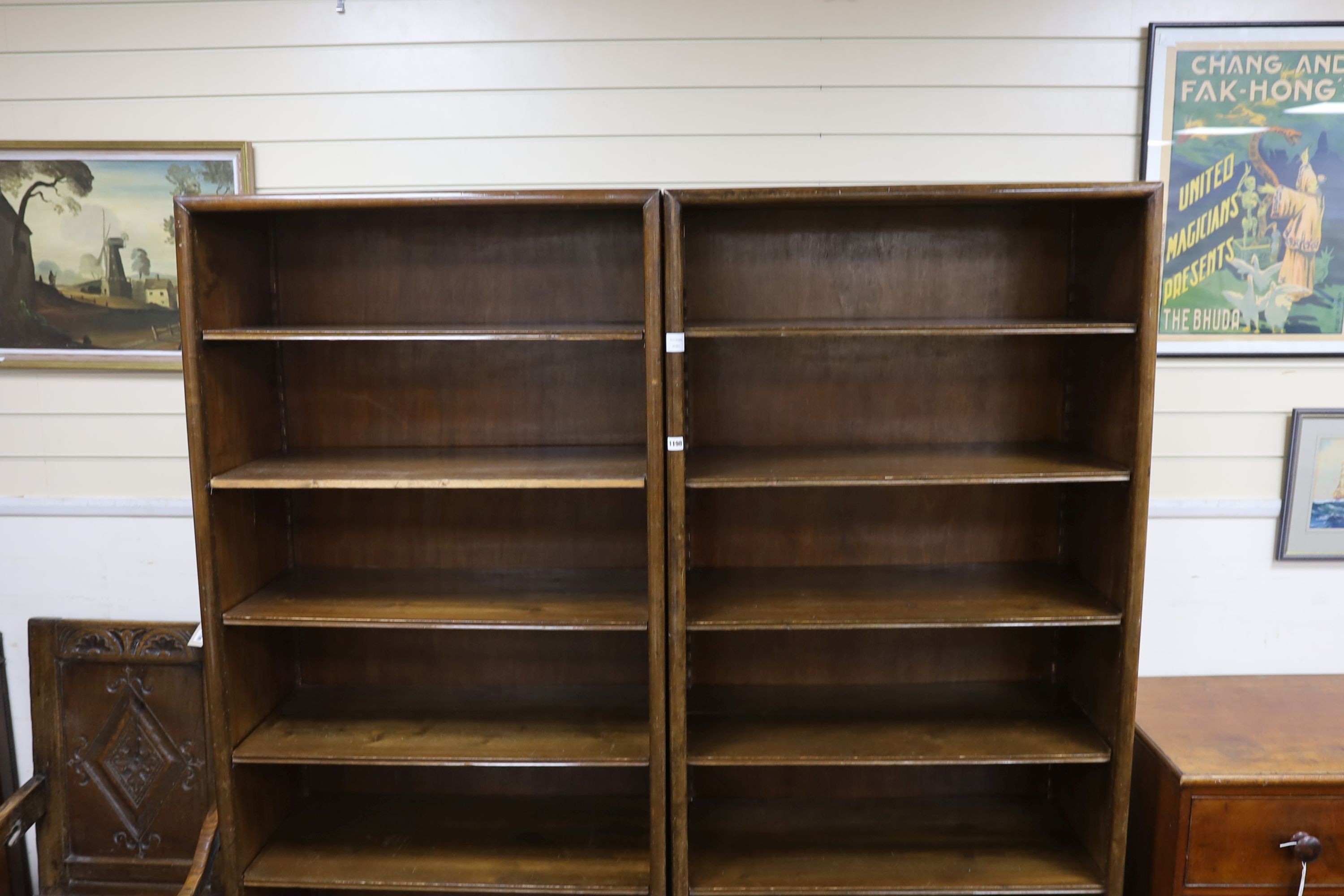 A pair of Hungarian mahogany and pine open fronted bookcases, with adjustable shelving, each width 89cm, depth 40cm, height 200cm